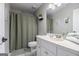 Bathroom featuring white vanity, toilet and shower with green curtain at 345 Kerrith Dr, Stockbridge, GA 30281