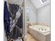 Bright bathroom with a soaking tub, separate shower, and a skylight at 345 Kerrith Dr, Stockbridge, GA 30281