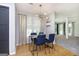 Dining area with a modern light fixture, light-colored wood floors, and large windows for natural light at 345 Kerrith Dr, Stockbridge, GA 30281