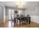 Dining room with a wood table, bench and chair seating, with light-colored wood floors at 345 Kerrith Dr, Stockbridge, GA 30281