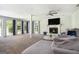 Spacious living room with ample natural light, a cozy fireplace, and plush seating for relaxation at 345 Kerrith Dr, Stockbridge, GA 30281