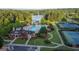 Overhead view showcasing community pool, tennis courts, clubhouse and adjacent lake in a lush wooded setting at 345 Kerrith Drive Dr, Stockbridge, GA 30281