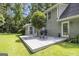 Backyard view showing the home's deck, grilling area, and mature trees at 345 Kerrith Drive Dr, Stockbridge, GA 30281