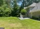 A spacious backyard featuring a patio area, lush green lawn, and mature trees providing shade and privacy at 345 Kerrith Drive Dr, Stockbridge, GA 30281