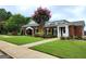 Professionally landscaped building with brick exterior, complemented by lush greenery, trees and a manicured lawn at 345 Kerrith Drive Dr, Stockbridge, GA 30281