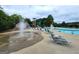 Splash fountain, zero-entry pool and waterslide in the community pool area, surrounded by seating at 345 Kerrith Drive Dr, Stockbridge, GA 30281