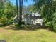 Charming two-story home with a well-manicured lawn and mature trees providing shade and privacy at 345 Kerrith Drive Dr, Stockbridge, GA 30281