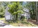 Exterior view showcasing the home's architecture and mature trees at 345 Kerrith Drive Dr, Stockbridge, GA 30281
