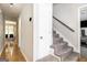 Hallway featuring wood floors, staircase, neutral paint and access to dining room and living area at 345 Kerrith Drive Dr, Stockbridge, GA 30281