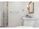 Bright bathroom featuring white shiplap walls, marble countertop, and glass shower enclosure at 3612 Bill Gardner Pkwy, Locust Grove, GA 30248