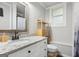 Bathroom features a granite vanity, wooden storage and decorative mirror at 3612 Bill Gardner Pkwy, Locust Grove, GA 30248