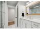 Bathroom with double sink vanity, white cabinets, and glass enclosed shower at 3612 Bill Gardner Pkwy, Locust Grove, GA 30248