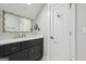 Bathroom featuring modern vanity with black cabinets, white countertop, and decorative gold mirror at 3612 Bill Gardner Pkwy, Locust Grove, GA 30248