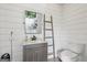 Bathroom features shiplap walls, modern fixtures, and rustic ladder at 3612 Bill Gardner Pkwy, Locust Grove, GA 30248