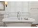 Bright bathroom featuring a white soaking tub, shiplap walls, and rustic framed mirror at 3612 Bill Gardner Pkwy, Locust Grove, GA 30248