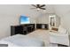 Cozy bedroom featuring unique window treatments, wood floors and ceiling fan at 3612 Bill Gardner Pkwy, Locust Grove, GA 30248