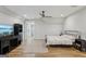 Bright bedroom features a ceiling fan, bed, and desk at 3612 Bill Gardner Pkwy, Locust Grove, GA 30248