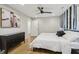 Charming bedroom with neutral walls, dark wood floors, and a black ceiling fan at 3612 Bill Gardner Pkwy, Locust Grove, GA 30248