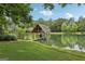 Picturesque boathouse on the lake, providing a serene spot for relaxation and water activities at 3612 Bill Gardner Pkwy, Locust Grove, GA 30248