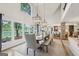 Bright dining room with high ceilings, modern lighting, and views of the backyard and lake at 3612 Bill Gardner Pkwy, Locust Grove, GA 30248