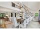 Open concept dining room with a large table, high ceilings, and views of the fireplace and living room at 3612 Bill Gardner Pkwy, Locust Grove, GA 30248