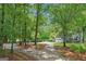 Tree-lined driveway leading to a home with a two-car garage, providing a welcoming approach at 3612 Bill Gardner Pkwy, Locust Grove, GA 30248