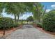 Long driveway with a secure, automatic gate, ensuring privacy and peace of mind at 3612 Bill Gardner Pkwy, Locust Grove, GA 30248