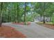 Long, private driveway winds through mature trees leading to a charming home at 3612 Bill Gardner Pkwy, Locust Grove, GA 30248