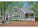 Charming home featuring shingle siding, a cozy firepit, and wraparound porch for scenic outdoor living at 3612 Bill Gardner Pkwy, Locust Grove, GA 30248
