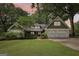 Charming home with white painted stone, shake accents, manicured lawn, and a two-car garage at dusk at 3612 Bill Gardner Pkwy, Locust Grove, GA 30248