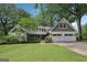 Charming home with white painted stone, shake accents, manicured lawn, and a two-car garage at 3612 Bill Gardner Pkwy, Locust Grove, GA 30248
