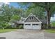 Charming home with white painted stone, shake accents, manicured lawn, and a two-car garage at 3612 Bill Gardner Pkwy, Locust Grove, GA 30248
