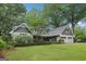 Charming home with white painted stone, shake accents, manicured lawn, and a two-car garage at 3612 Bill Gardner Pkwy, Locust Grove, GA 30248