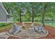 Outdoor firepit area with surrounding Adirondack chairs near the lake at 3612 Bill Gardner Pkwy, Locust Grove, GA 30248