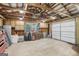 Spacious garage with exposed beams, overhead lighting, and built in cabinets at 3612 Bill Gardner Pkwy, Locust Grove, GA 30248