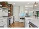 Modern kitchen with stainless steel appliances, custom cabinets, and a large island with hardwood floors at 3612 Bill Gardner Pkwy, Locust Grove, GA 30248