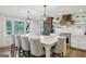 Elegant kitchen featuring a large island, custom cabinets, stainless steel appliances, and views of the lake at 3612 Bill Gardner Pkwy, Locust Grove, GA 30248