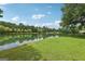 Scenic lake view featuring lush greenery and a tranquil water feature on a sunny day at 3612 Bill Gardner Pkwy, Locust Grove, GA 30248