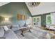 Spacious living room with vaulted ceiling, hardwood floors, and doors leading to the outdoor deck at 3612 Bill Gardner Pkwy, Locust Grove, GA 30248