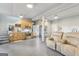 This large living space features a kitchen and a reclining sofa, with stairs in the background at 3612 Bill Gardner Pkwy, Locust Grove, GA 30248