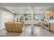 This large living space features a kitchen and a reclining sofa, with windows in the background at 3612 Bill Gardner Pkwy, Locust Grove, GA 30248