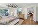 Spacious primary bedroom featuring wood floors, ceiling fan, and view to lake at 3612 Bill Gardner Pkwy, Locust Grove, GA 30248