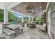 Outdoor pavilion with stone fireplace, TV, and seating area offers a luxurious space for relaxation by the pool at 3612 Bill Gardner Pkwy, Locust Grove, GA 30248