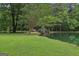 Scenic pond with a charming bridge and lush greenery, perfect for a peaceful retreat and enjoying nature at 3612 Bill Gardner Pkwy, Locust Grove, GA 30248
