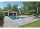 Backyard boasts luxurious pool, pavilion, and lush landscaping for ultimate relaxation and outdoor entertaining at 3612 Bill Gardner Pkwy, Locust Grove, GA 30248