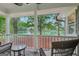 Covered porch overlooking a beautiful lake with wicker seating at 3612 Bill Gardner Pkwy, Locust Grove, GA 30248