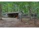 View of shed and chicken coop, surrounded by lush trees at 3612 Bill Gardner Pkwy, Locust Grove, GA 30248
