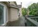 Side view of wooden back deck with grill and view of backyard landscaping at 12043 Olmstead Dr, Fayetteville, GA 30215