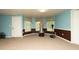Basement with neutral carpet, recessed lighting, blue and brown paint and workout equipment at 12043 Olmstead Dr, Fayetteville, GA 30215