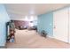 Finished basement with a living area, neutral carpet, and blue and brown paint scheme at 12043 Olmstead Dr, Fayetteville, GA 30215